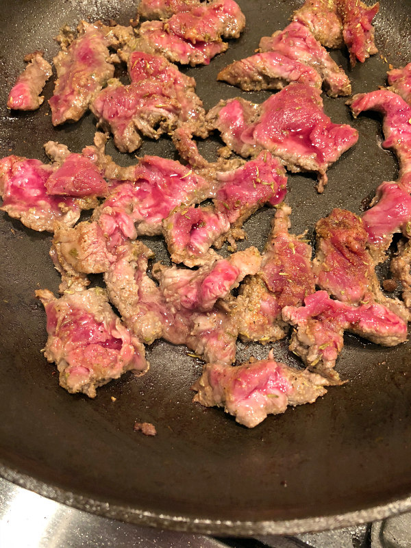 Flank Steak sauteeing in pan