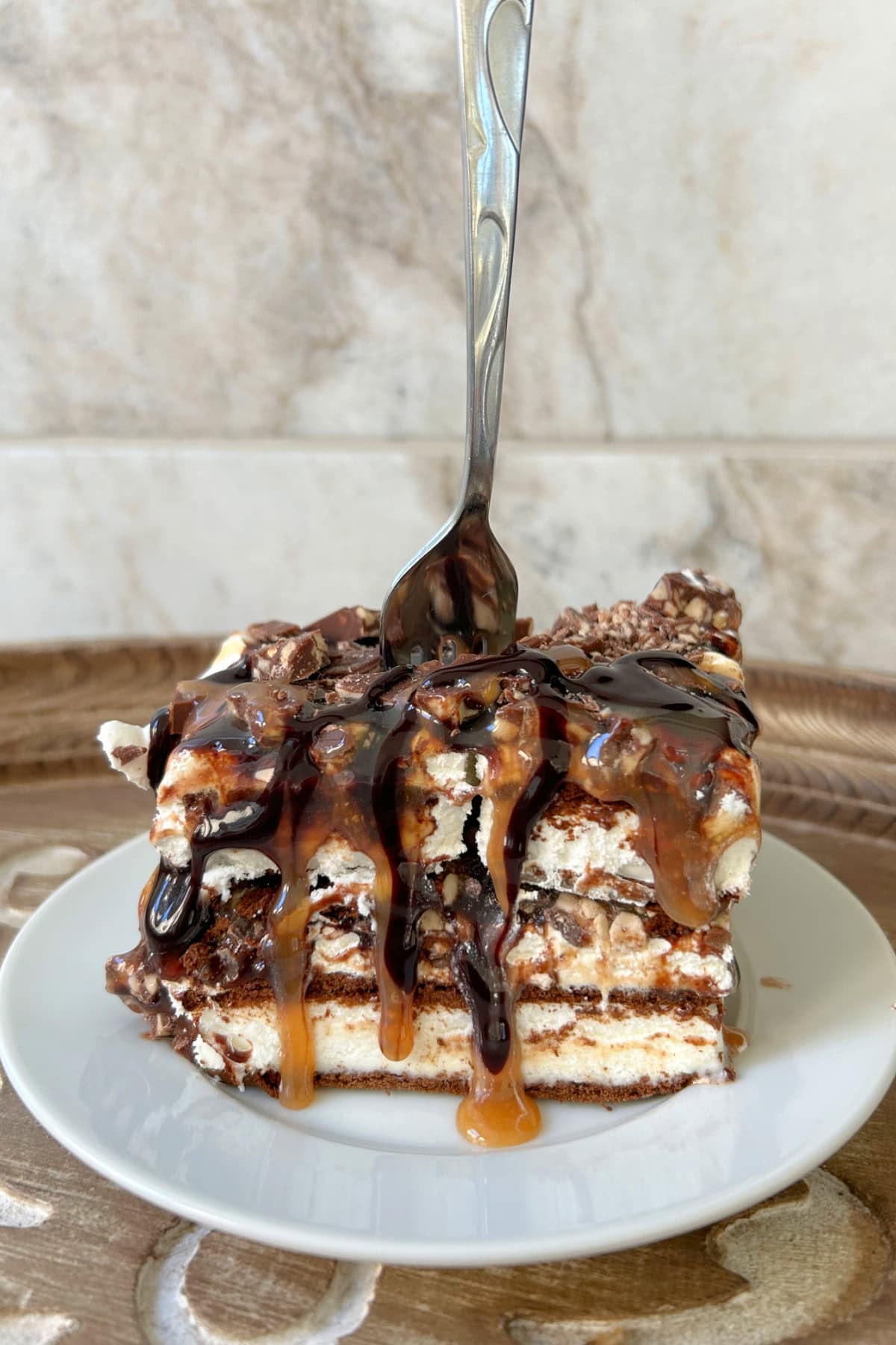 fork in a slice of frozen caramel toffee ice cream sandwich dessert