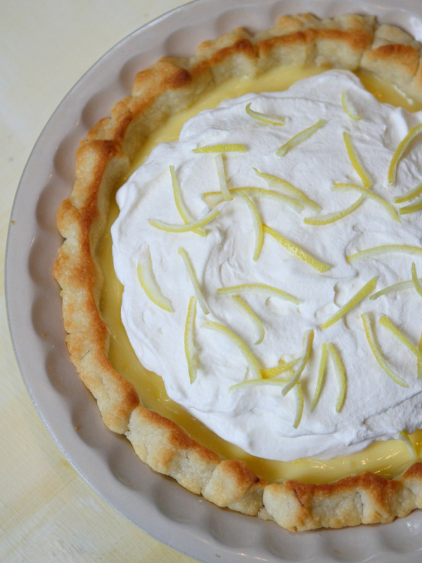 lemon sour cream pie garnished with lemon rind