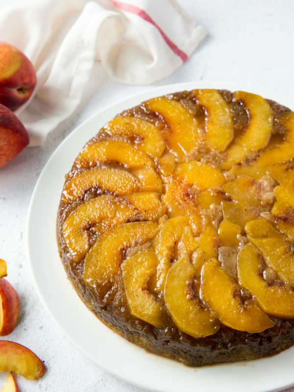 peach upside down cake on a white plate