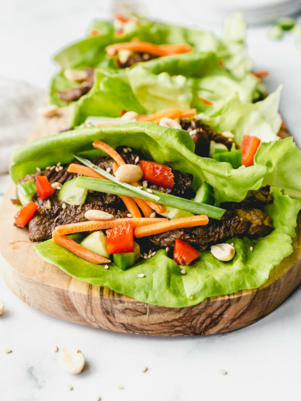 bulgogi beef lettuce wraps on a wooden cutting board