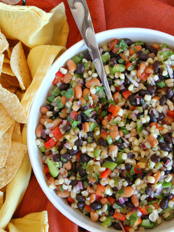 overhead shot of texas caviar in a white bowl served with tortilla chips