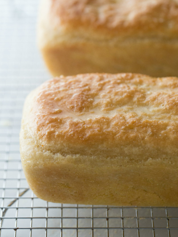 two loaves of english muffin bread cooling on a cooling rack