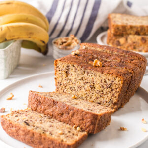 2 banana bread loaf on plate slices open