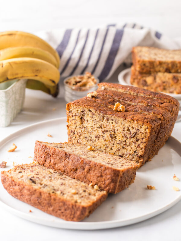 2 banana bread loaf on plate slices open