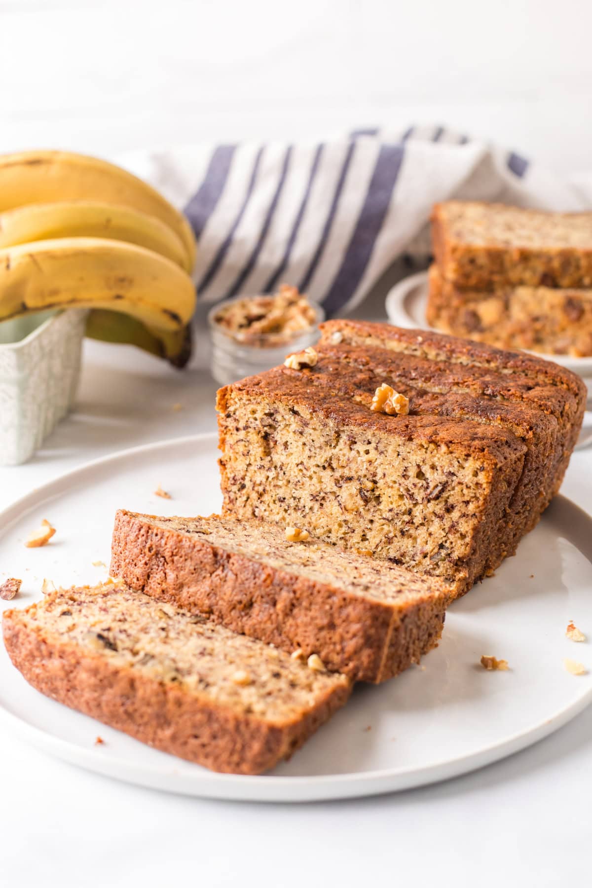 2 banana bread loaf on plate slices open