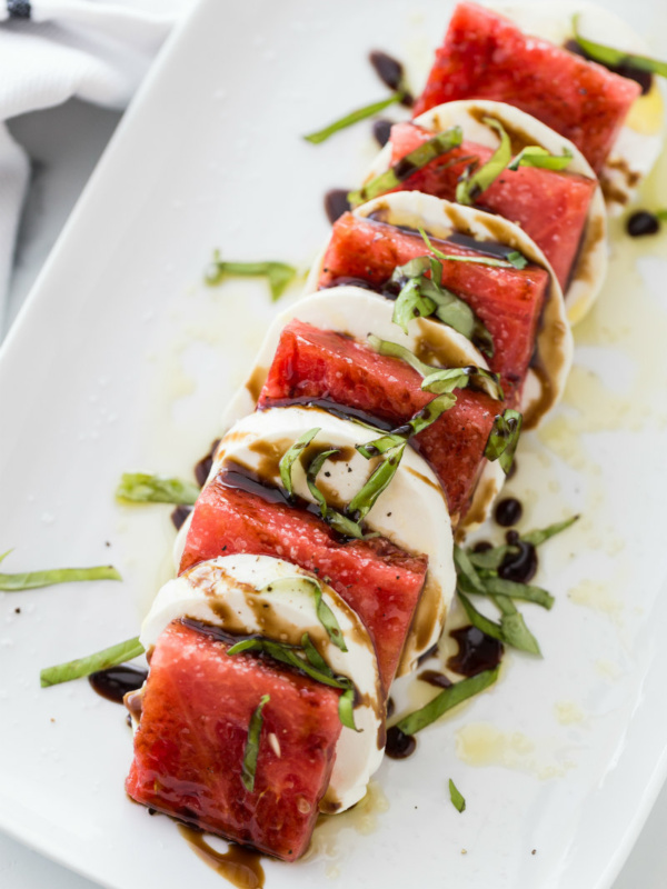 watermelon caprese salad on a white plate