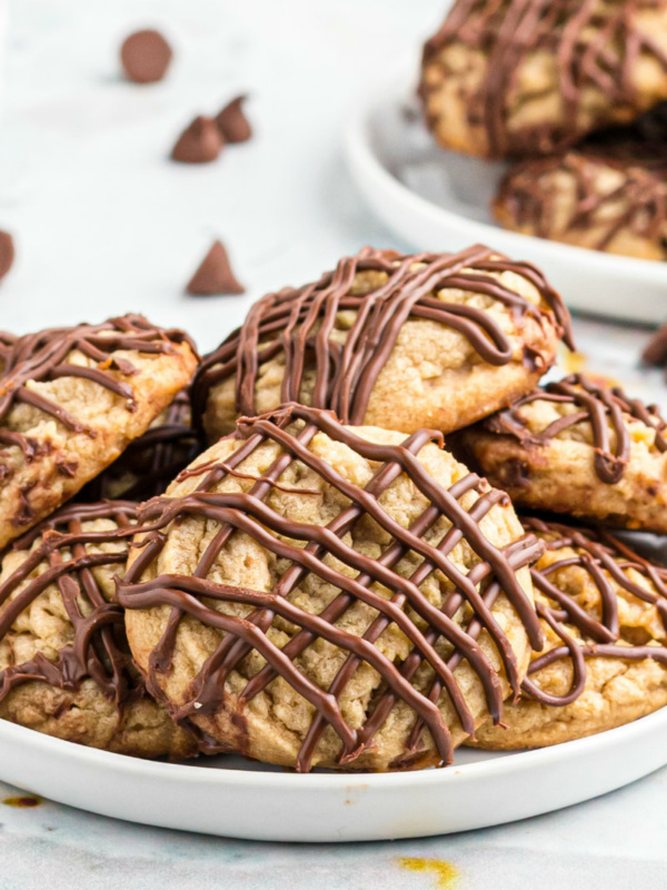 chocolate drizzled peanut butter cookies on white platter