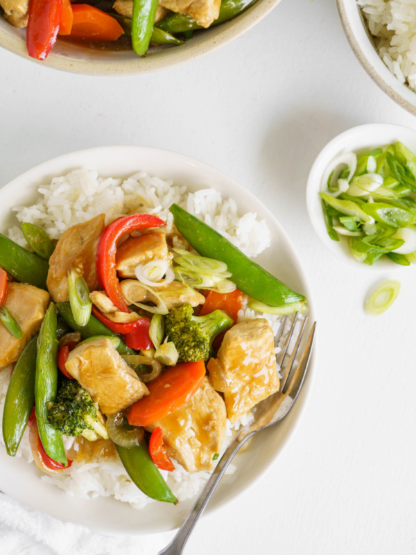 stir fry on a white plate with rice