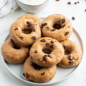 2 ingredient cinnamon raisin bagels on white plate with bowl of cream cheese