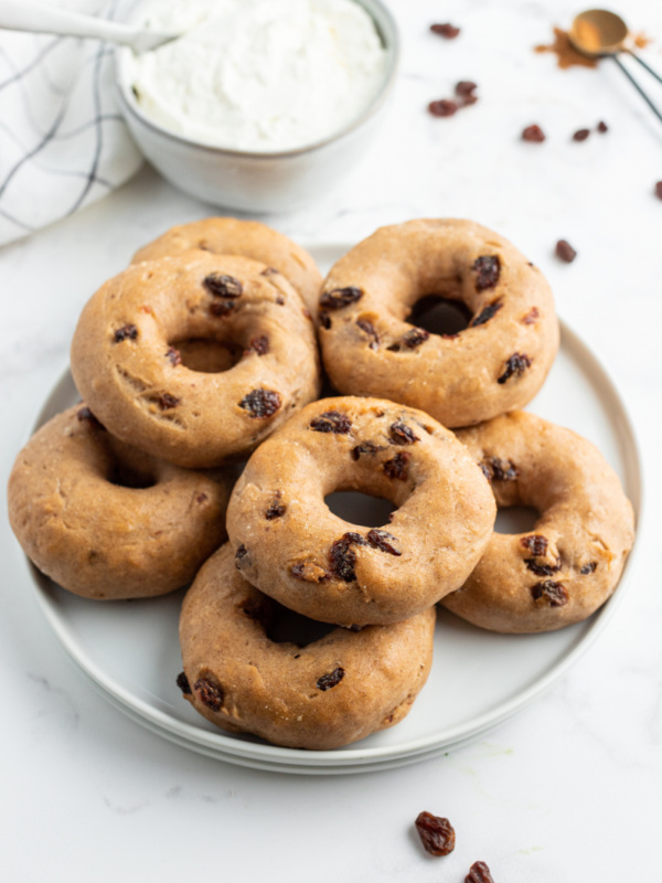 2 ingredient cinnamon raisin bagels on white plate with bowl of cream cheese