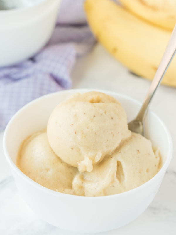 scoops of banana ice cream in a white dish