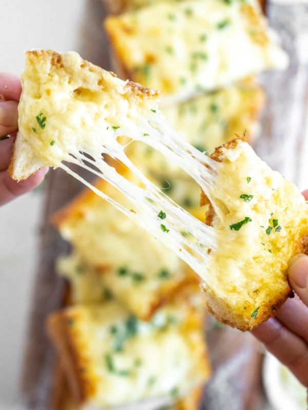 pulling cheesy garlic bread apart