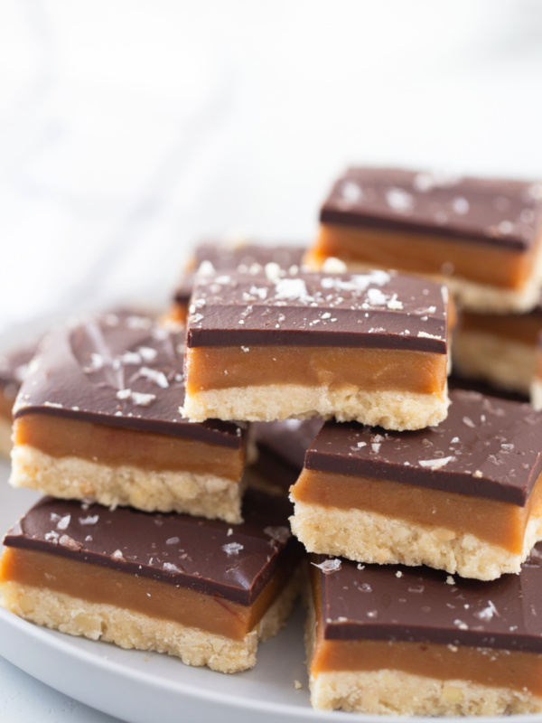 several pieces of millionaire shortbread stacked on a platter