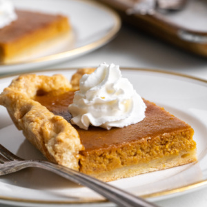 slice of pumpkin slab pie on plate with whipped cream