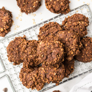 no bake chocolate peanut butter cookies stacked on cooling rack