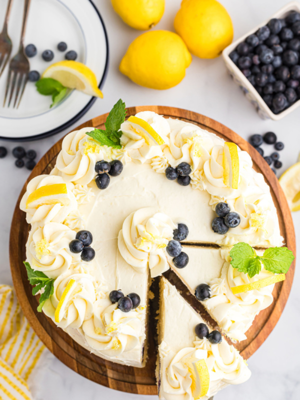 overhead shot of blueberry cheesecake cake with a couple of slices cut