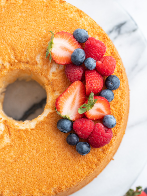 overhead shot of angel food cake with fresh berries on top