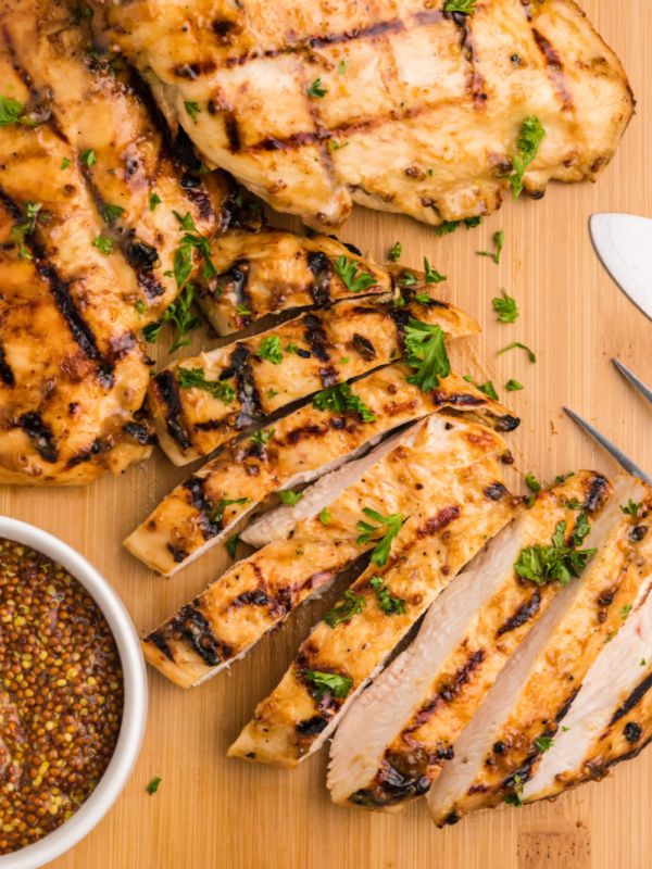 honey mustard grilled chicken sliced on cutting board