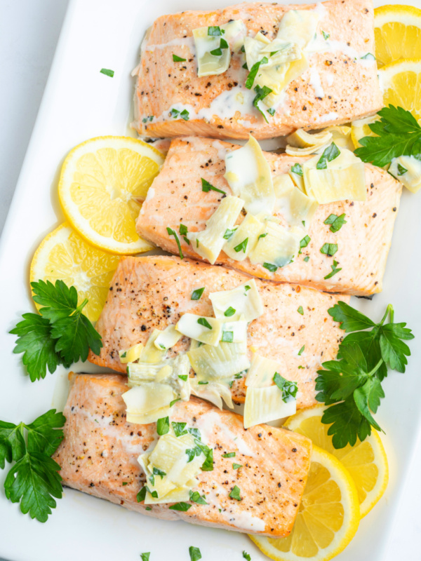 air fryer salmon fillets topped with chardonnay butter sauce and lemon slices