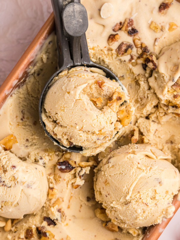 scoops of maple walnut ice cream on top of tub of ice cream