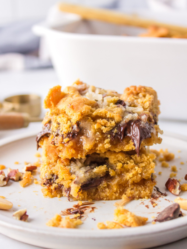 two peanut butter fudge bars stacked on plate