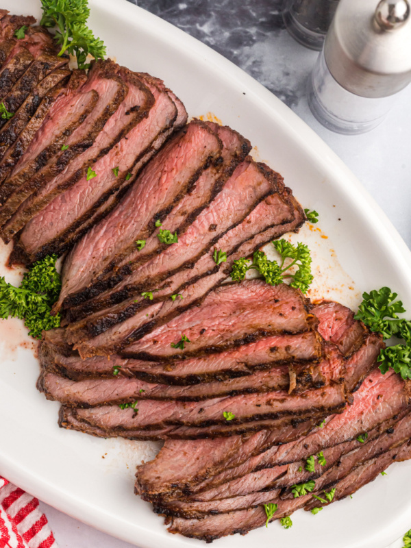 sliced tri tip on a platter