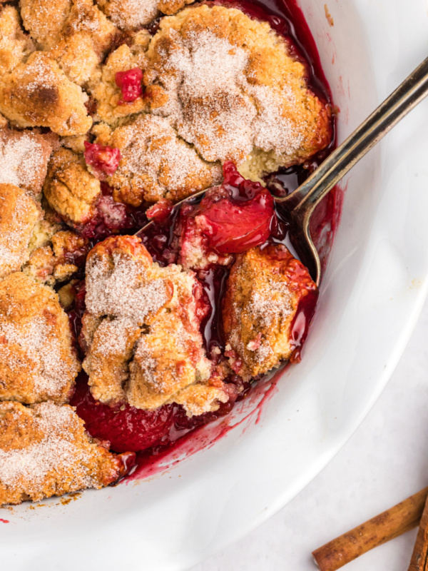 plum cobbler with spoon in it