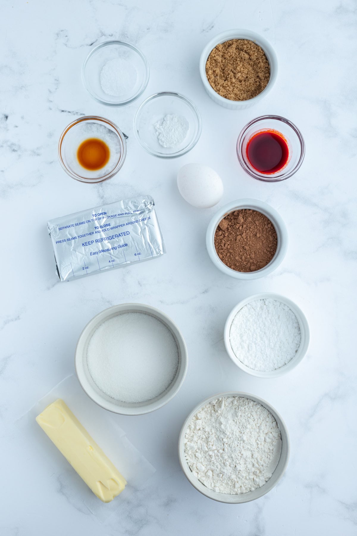 ingredients displayed for making cheesecake stuffed red velvet cookies