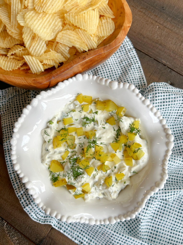 overhead shot of dill pickle dip and potato chips