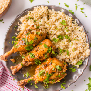 coconut chicken drumsticks on a plate with rice