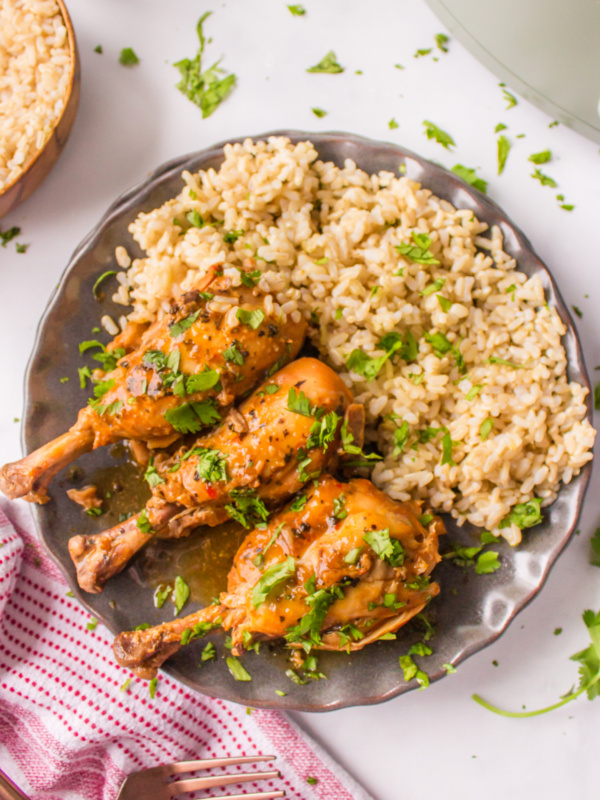 coconut chicken drumsticks on a plate with rice