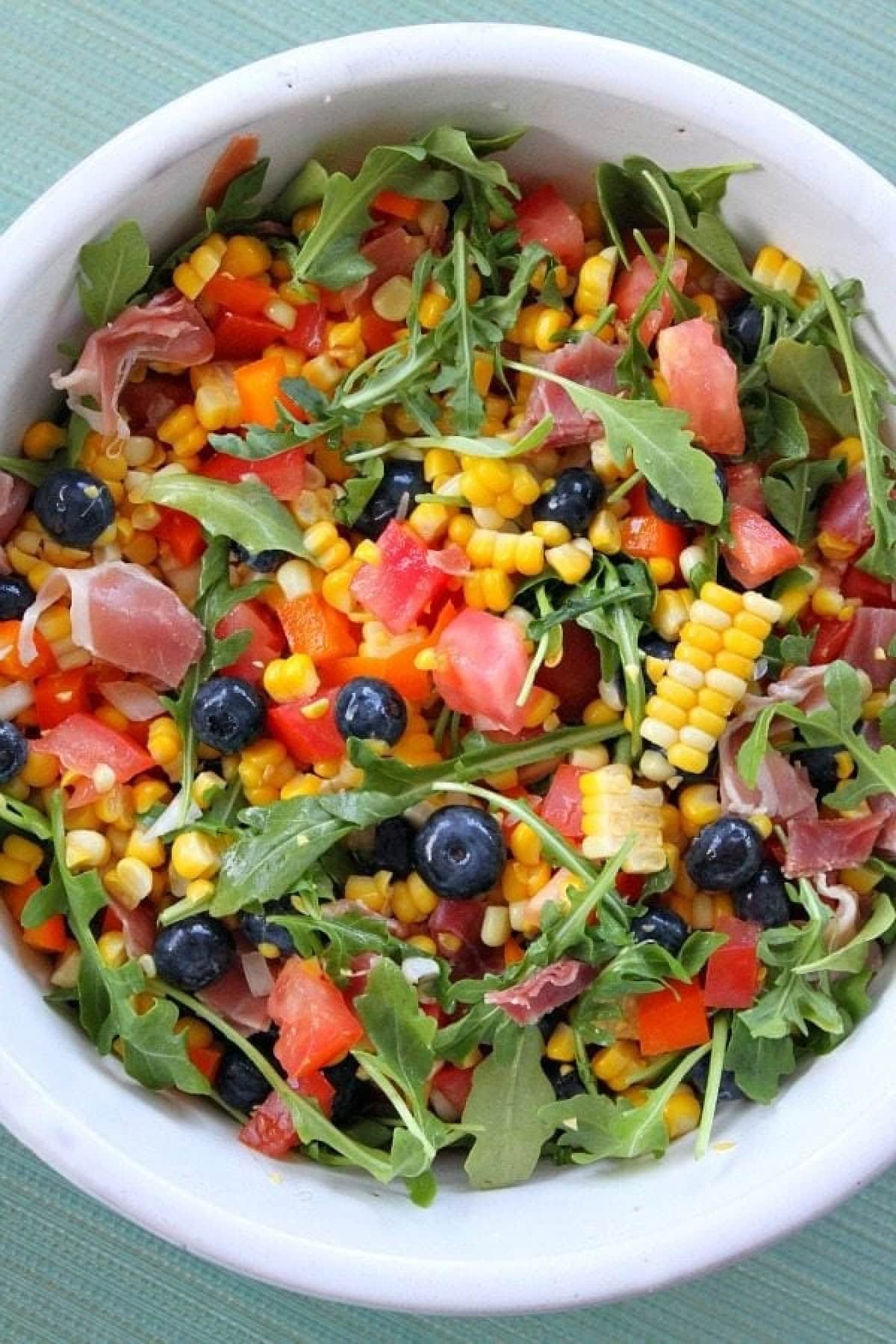 bowl of blueberry corn salad with prosciutto
