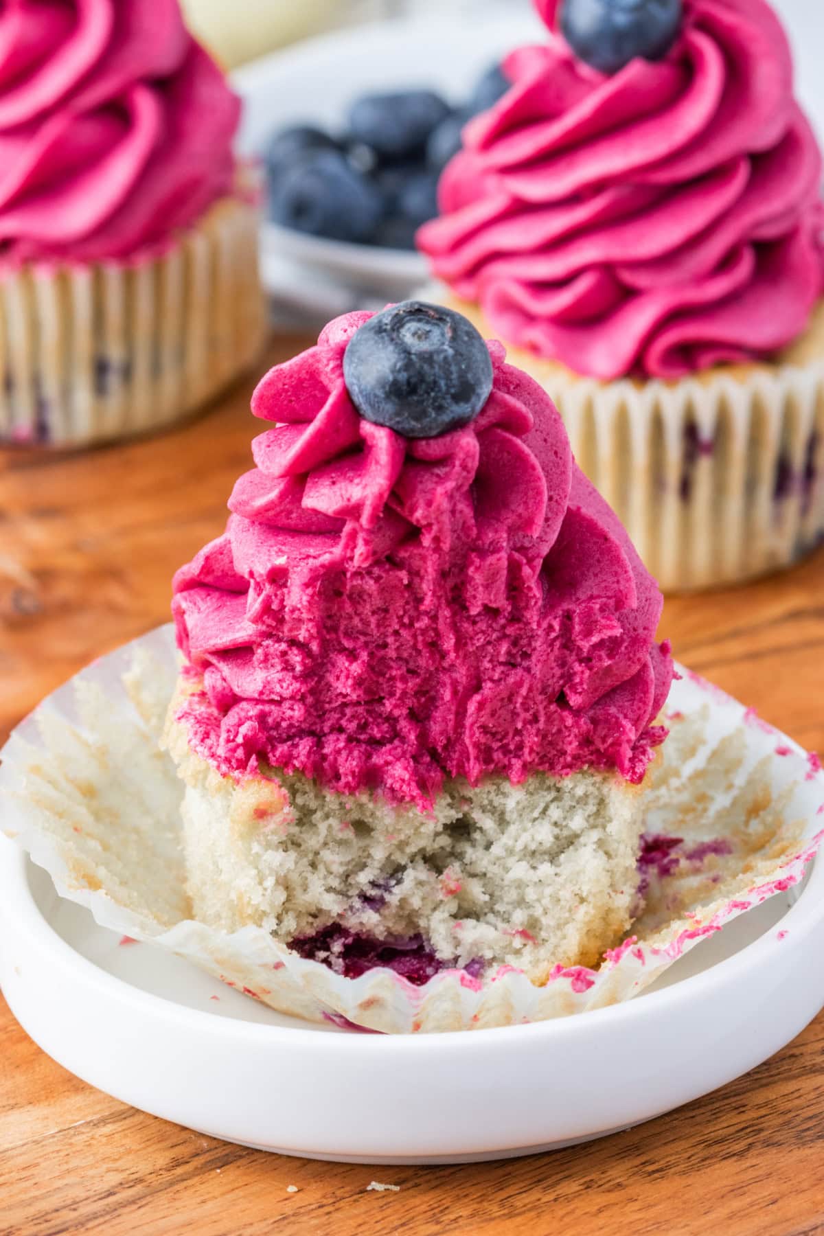 blueberry cupcake with frosting sliced open