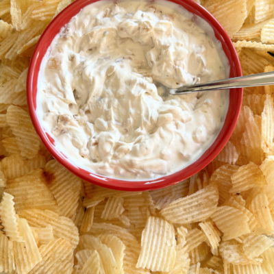 caramelized onion dip in a bowl surrounded by chips