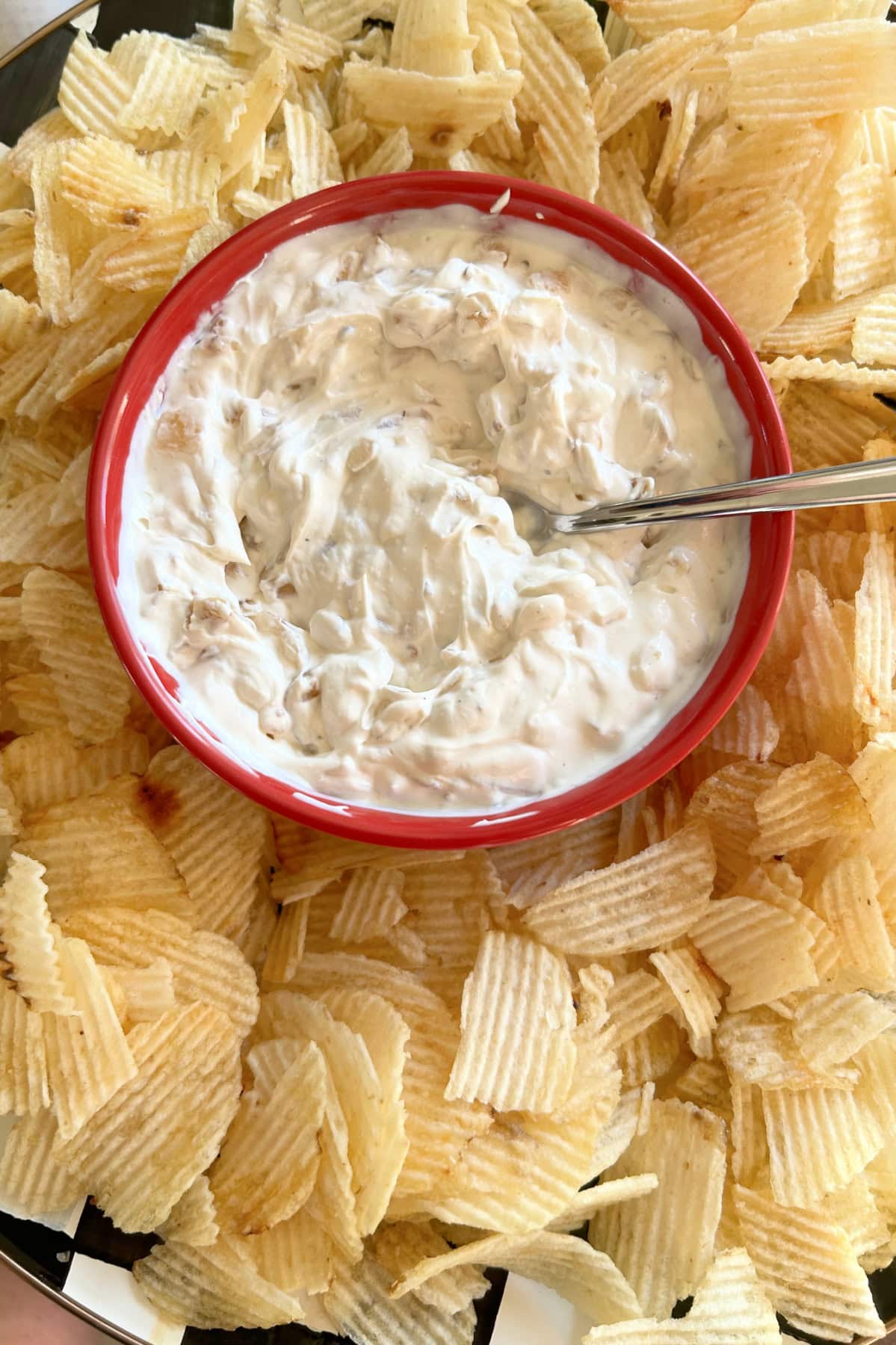 caramelized onion dip in a bowl surrounded by chips