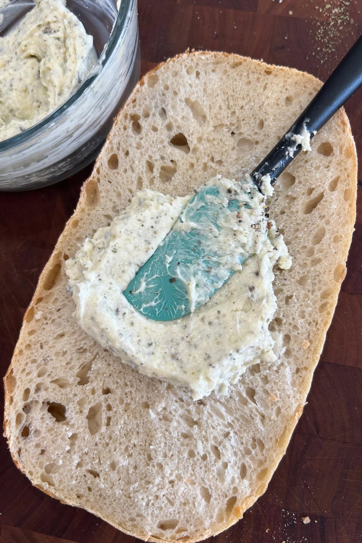 spreading garlic bread spread onto bread