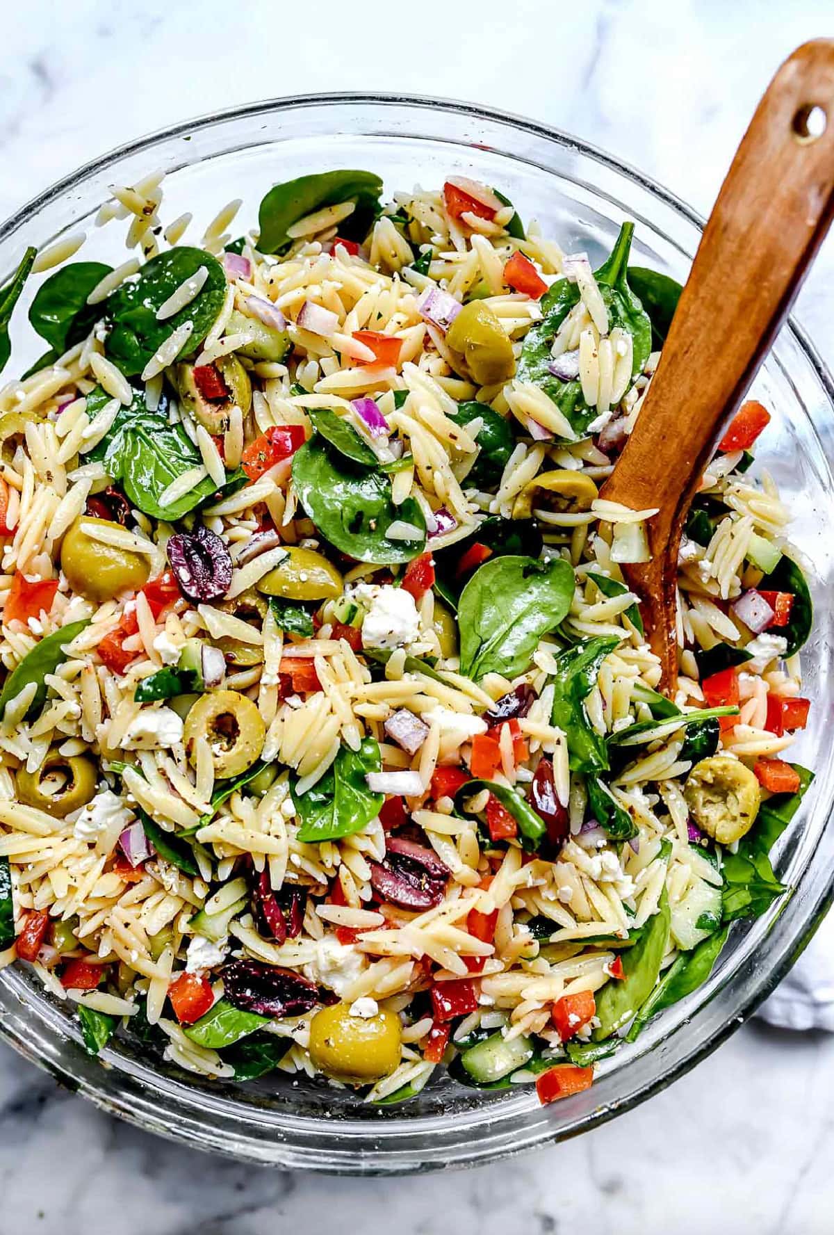 mediterranean orzo salad in a bowl with spoon