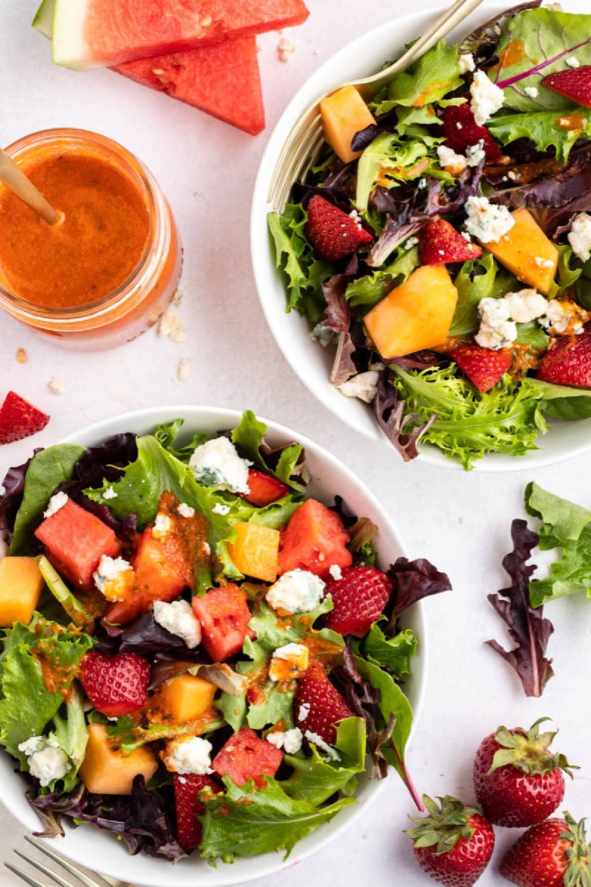 two bowls of strawberry melon salad with watermelon vinaigrette