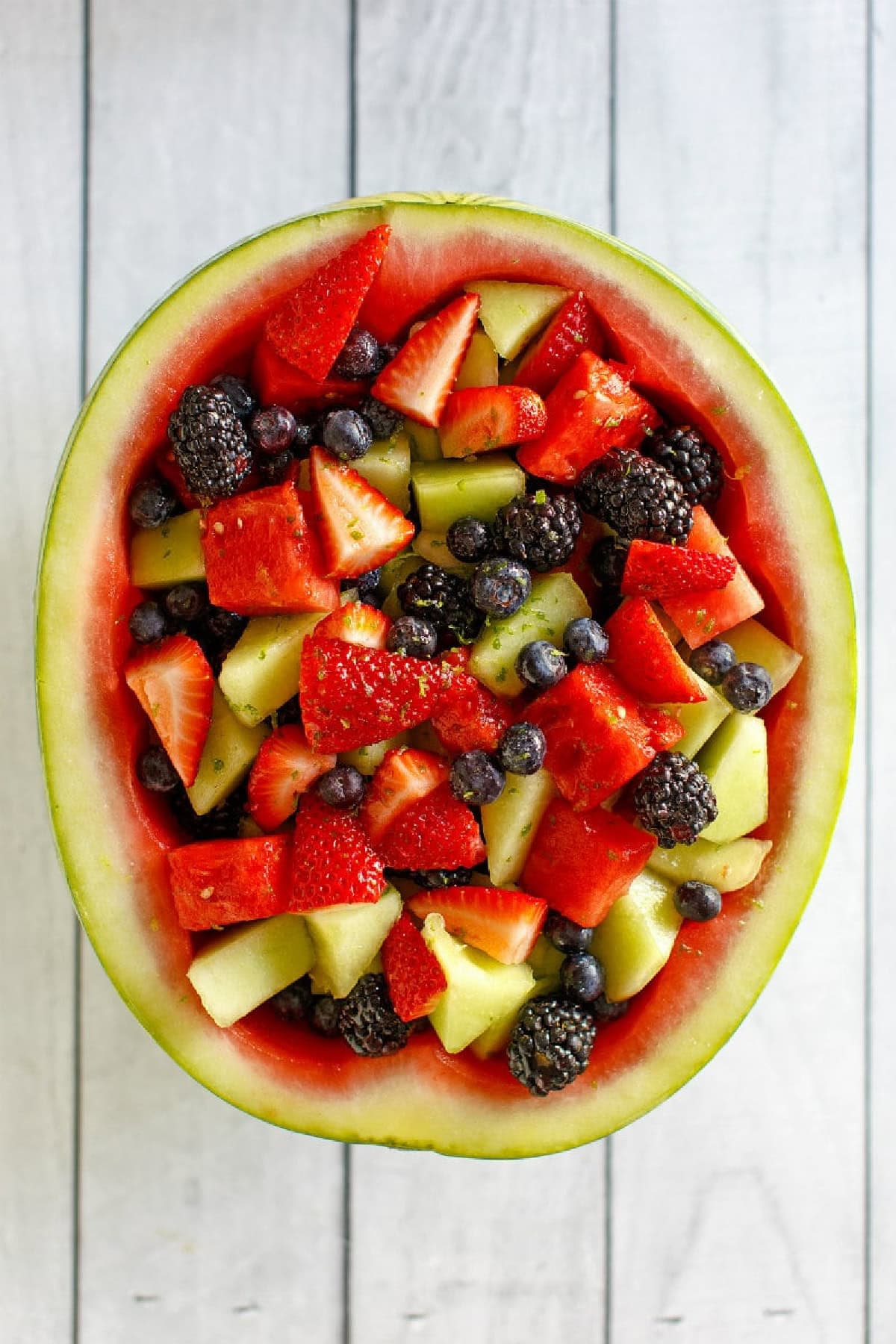 hollowed out watermelon half with spiked watermelon fruit inside