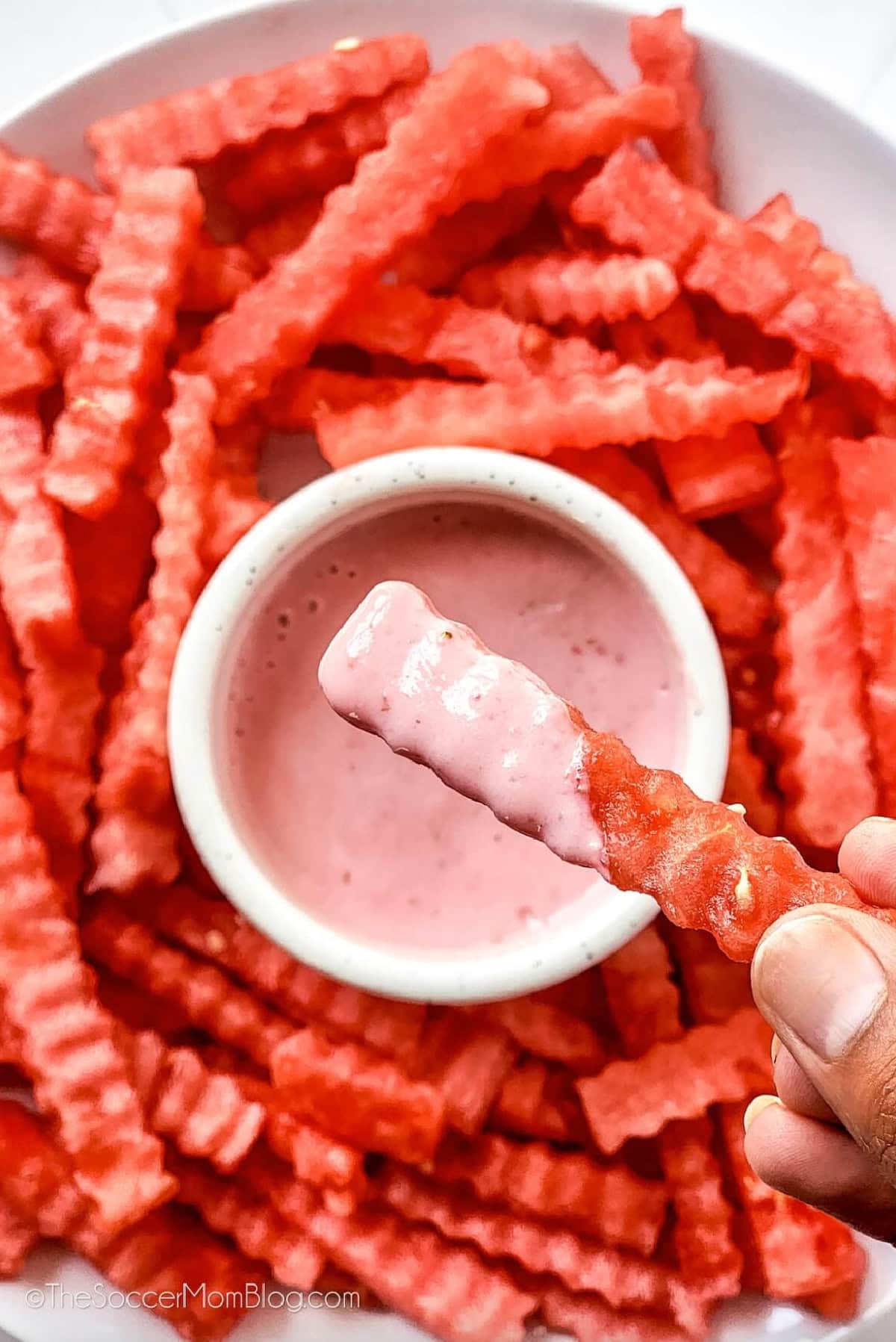 watermelon fries on a plate with bowl of dip