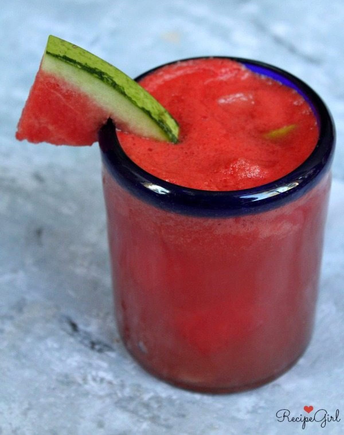 glass of watermelon gin fizz with watermelon wedge