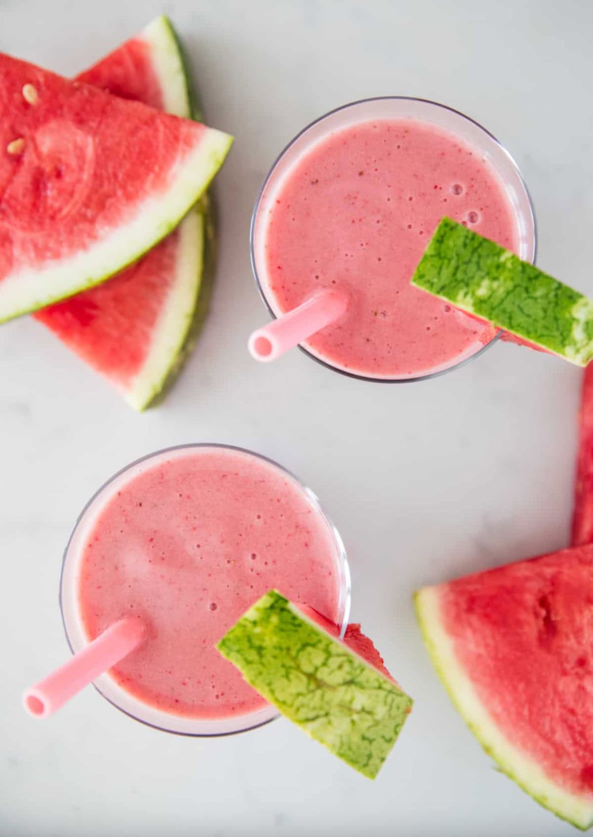 overhead shot of watermelon smoothies with watermelon wedges