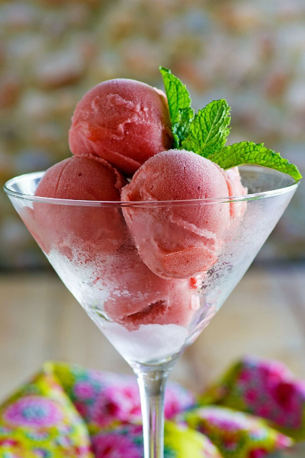 scoops of watermelon sorbet in glass with mint