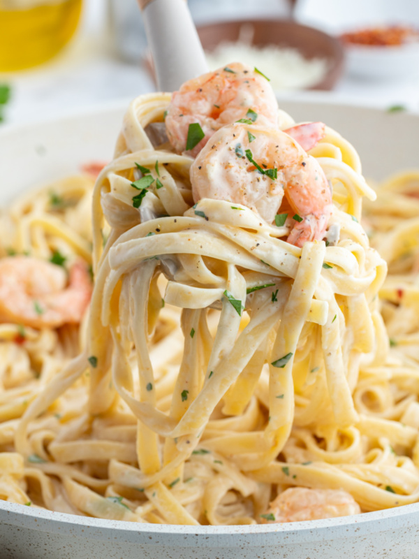 big fork full of shrimp scampi alfredo