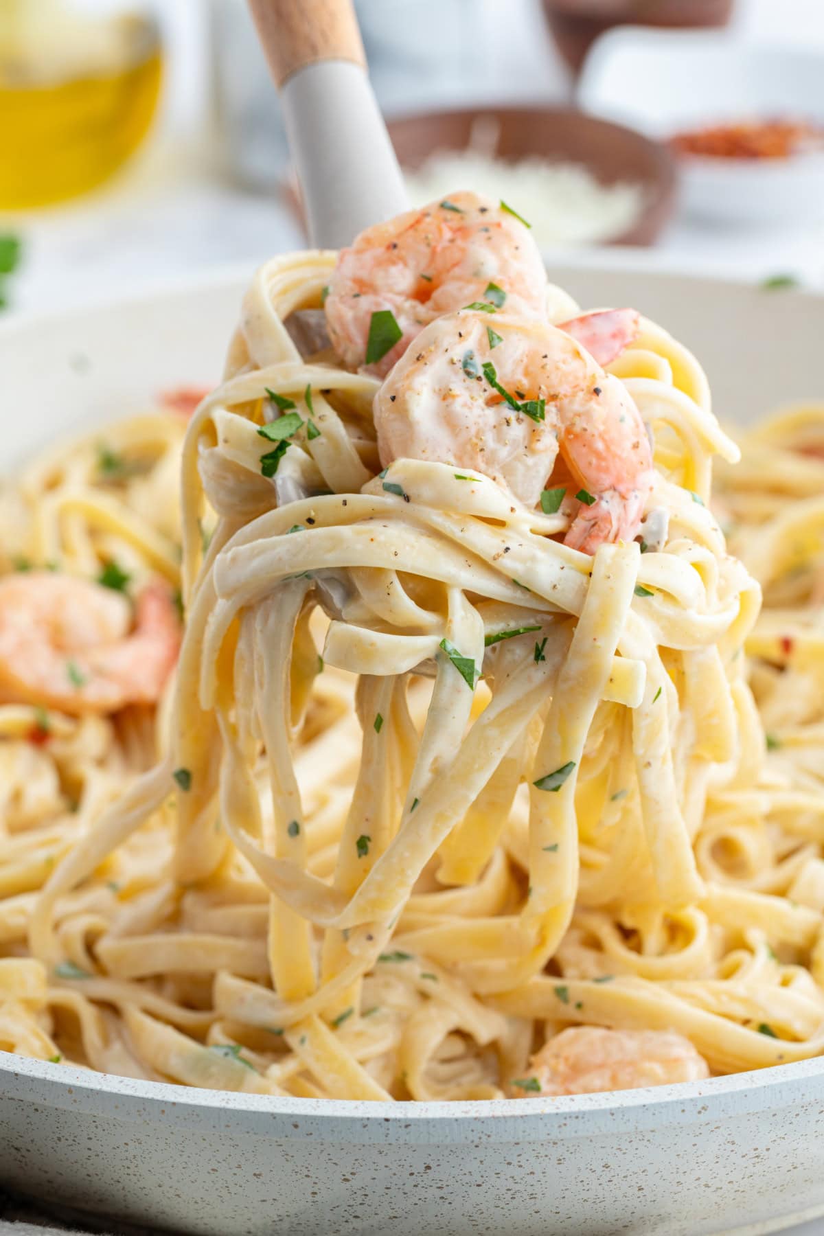 big fork full of shrimp scampi alfredo