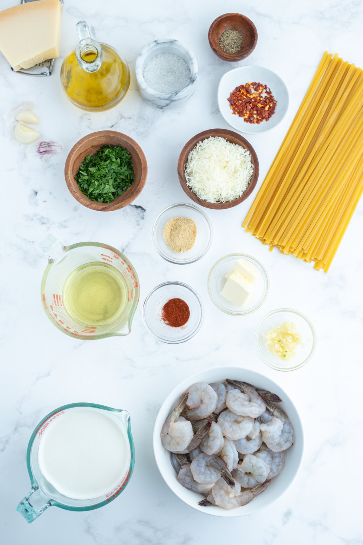 ingredients displayed for making shrimp scampi alfredo