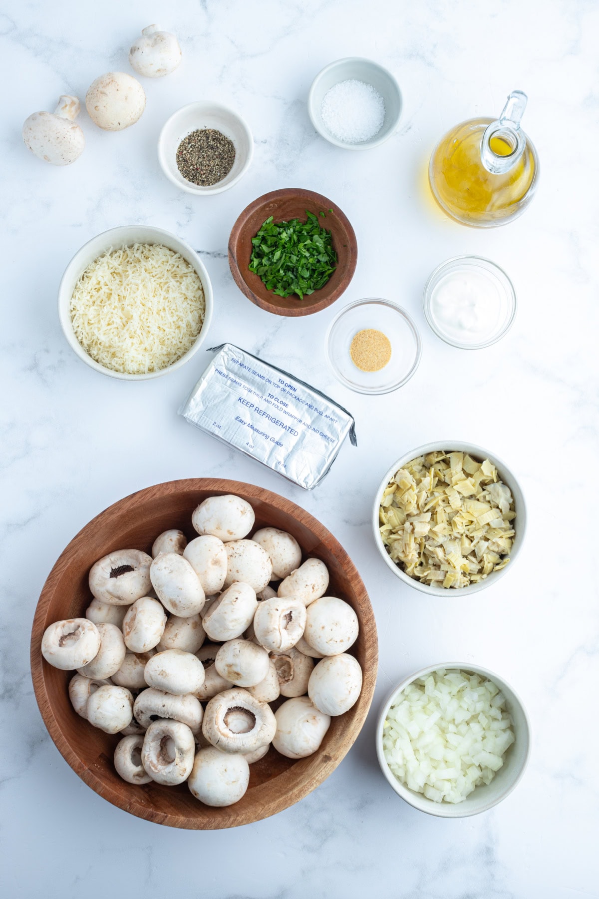 ingredients displayed for making artichoke stuffed mushrooms