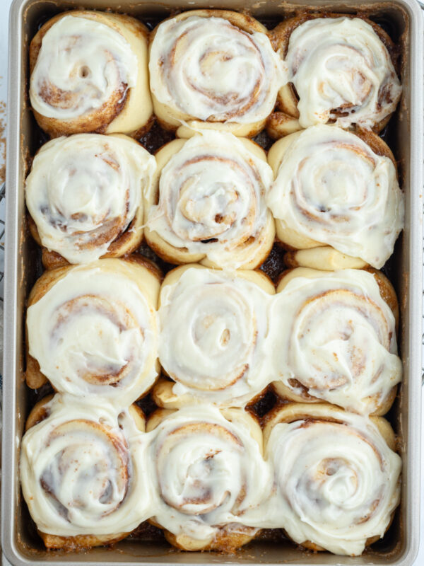 copycat cinnabon cinnamon rolls in pan with icing