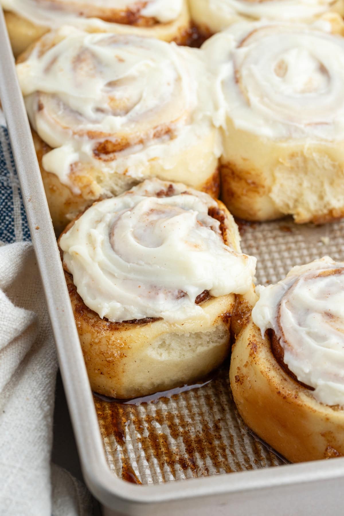 cinnamon rolls in metal pan with icing